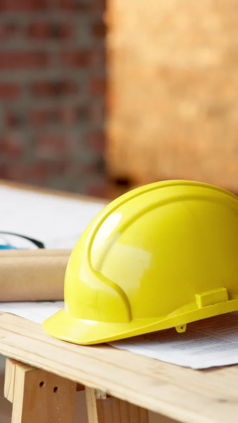Helmet, blueprint and table at construction site for planning, renovation or Stock Footage 338372738