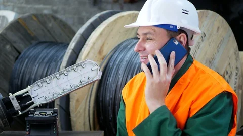 Helmet engineer talking on a cell phone. Stock Footage 128932768