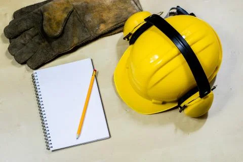 Helmet, hearing protection, tools, workshop table. Safety equipment and tools Stock Photos