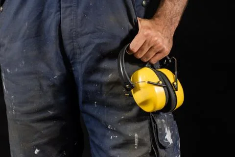 Helmet held by a construction worker. Protective clothing for manual workers. Stock Photos