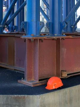 Helmet orange worker on the background of the construction site Stock Photos