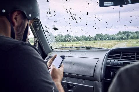 Helmeted navigator plots a route using a map of a modern smartphone Fotos de archivo