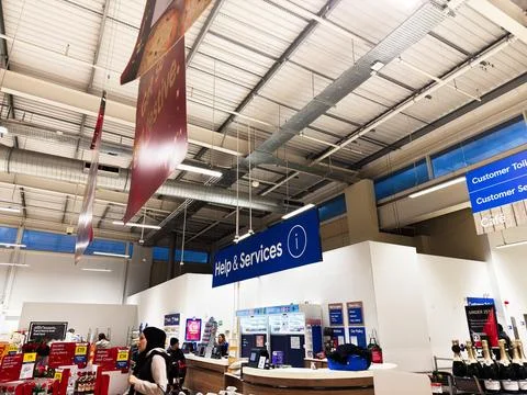 Help and Services desk at Manchester store, UK, with customers, cafe, and b.. Stock Photos