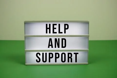 Help And Support text on light box on green background 스톡 사진