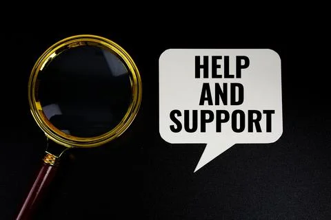 Help and Support text on speech bubble with magnifying glass top view on bl.. 스톡 사진