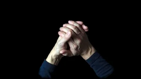 Help concept on a black background. Two hands make a sign of friendship and h Stock Photos