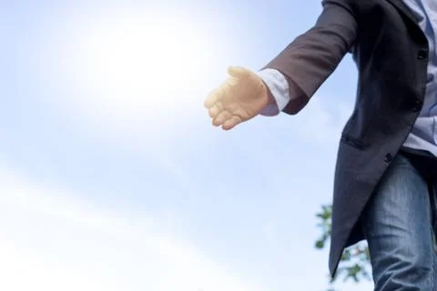 Help concept hand reaching out to help someone with blue sky Stock Photos