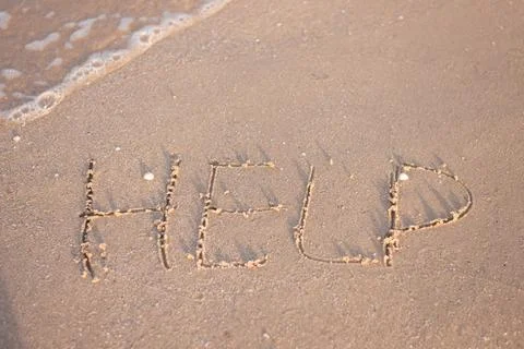Help concept. word in the sand Stock Photos