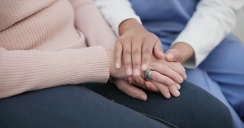 Help, empathy and holding hands with nurse with old woman on sofa for medical Stock Footage 254910933