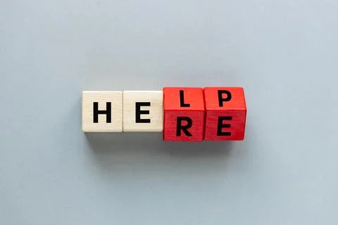 Help Here Symbol. The word "Help" written on wooden blocks  Stock Photos