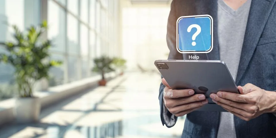 Help Icon Displayed on Tablet Device in Modern Office Environment Stock Photos