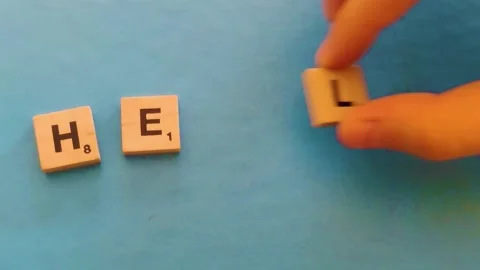 Help me Spell. The Hand of a Young Girl Lays out the Letters. Stock Footage 231142726