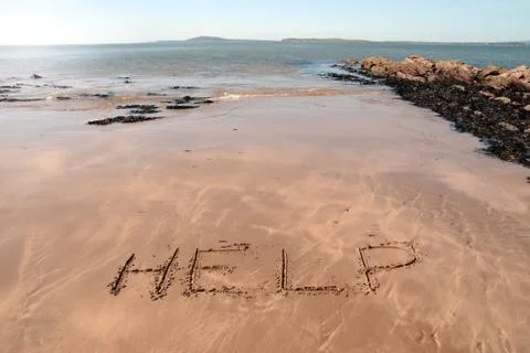 Help in sand Stock Photos