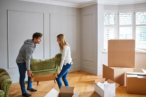 Help, sofa and couple in new home for moving, packing furniture and relocation Stock Photos