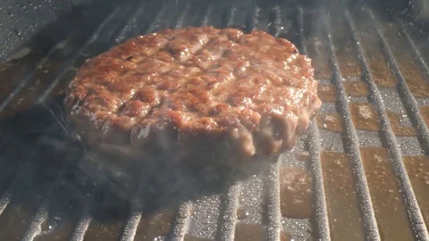 With the help of spatula, the cutlet is grilled, pressed harder to the hot Stock Footage 115775688