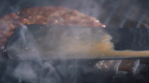 With the help of spatula, the cutlet is grilled, pressed harder to the hot Stock Footage 115775857
