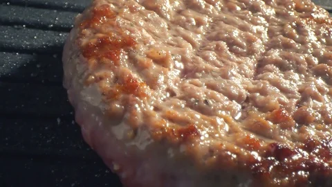 With the help of spatula, the cutlet is grilled, pressed harder to the hot Stock Footage 115776384