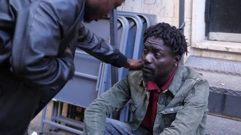 Help, support-young african offers asylum and help to a migrant like him Stock Footage 240391382