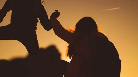 Help team concept. couple team silhouette of two climber stretching a helping Stock Footage 165053038
