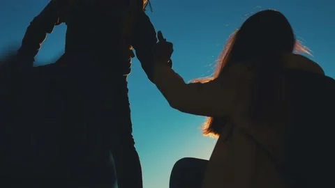 Help team concept. couple team silhouette of two climber stretching a helping Stock Footage 168100965