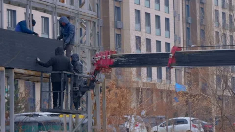 With the help of telescopic lift, men are dismantling outdoor large led screen Stock Footage 229826329