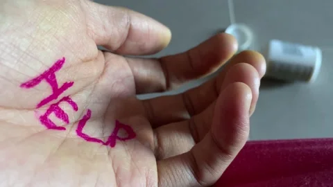 "HELP" text written on palm close up. Pill bottle on ground. Drug overdose Видео 196933902