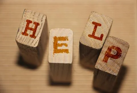 Help word collected of wooden elements with the letters. SOS help concept 스톡 사진