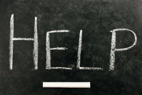 Help, written on a blackboard Fotos de archivo