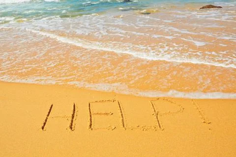 Help! - written in sand on the beach Foto stock