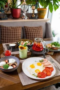 Helpful appetizing breakfast on a white plate. Scrambled eggs with vegetables Stock Photos