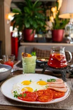 Helpful appetizing breakfast on a white plate. Scrambled eggs with vegetables Stock Photos