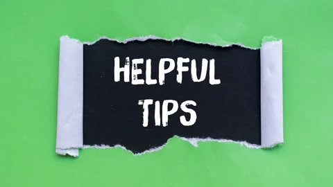 Helpful tips message writing on ripped torn paper background Stock Footage 344538572