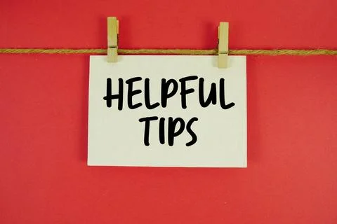 Helpful Tips paper notes hanging on the rope with clothespins Stock Photos
