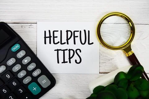 Helpful Tips text message with calculate and magnifying glass top view on w.. Stock Photos