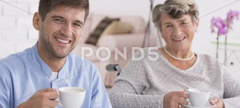 Helpful volunteer and his elder charge Stock Photos