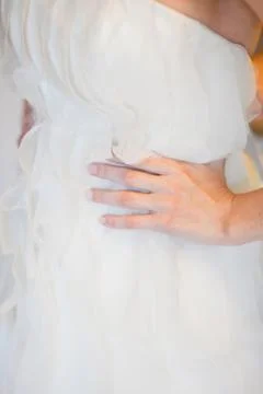 Helping the bride to put her wedding dress on Stock Photos