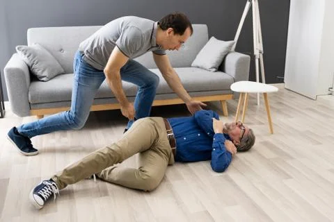 Helping Elder Senior Fallen Man After Fall Stock Photos