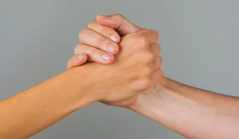 Helping hand. Gesture, sign of help and hope. Two hands taking each other. Pe Stock Photos