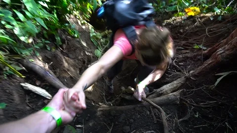 Helping Hand Pulling Up Young Woman While Hiking In Forest [Slow Motion] Stock Footage 88884133