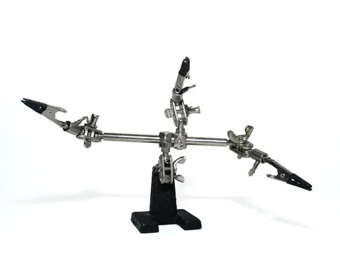 Helping hand, third hand or auxiliary clip tool, platinum holder in front o.. Stock Photos