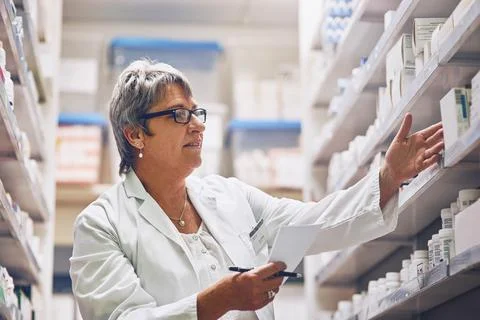Helping patients to maintain and optimize their health. Shot of a pharmacist  Stock Photos