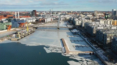 Helsinki, Finland. Aerial view of the city, modern bridge and frozen river Stock Footage