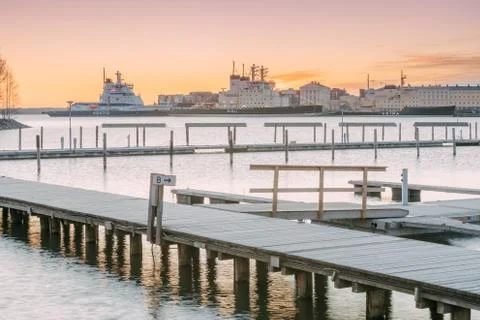 Helsinki, Finland. Landscape With City Pier, Jetty At Winter Sunrise Or Sunset Stock Photos