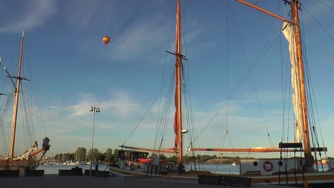 Helsinki, Finland. Two balloons float in the sky over sailing ships. Stock Footage 105053282