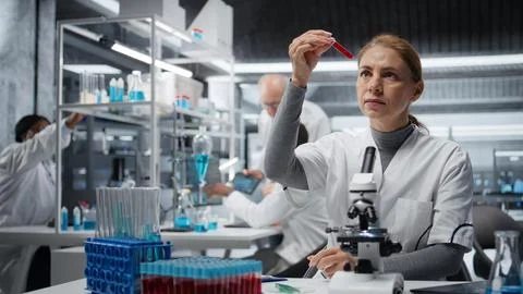 Hematology expert in lab analyzing batch of blood samples Stock Photos