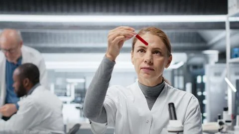 Hematology expert in lab analyzing batch of blood samples Stock Photos