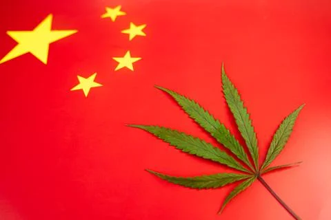 Hemp leaf on background of the chinese flag. Concept of legalization and ch.. Stock Photos