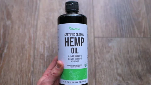 Hemp oil from seeds, cold pressed organic unrefined raw food by Vitacost Stock Footage 336781348