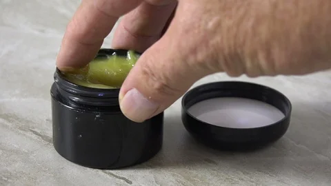 Hemp or CBD ointment in a jar Stock Footage 116859624