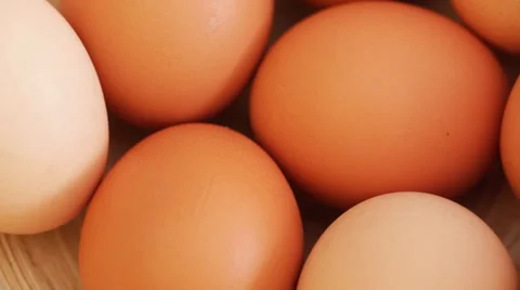Hen eggs in basket on rotating stand - closeup Stock Footage 50798964